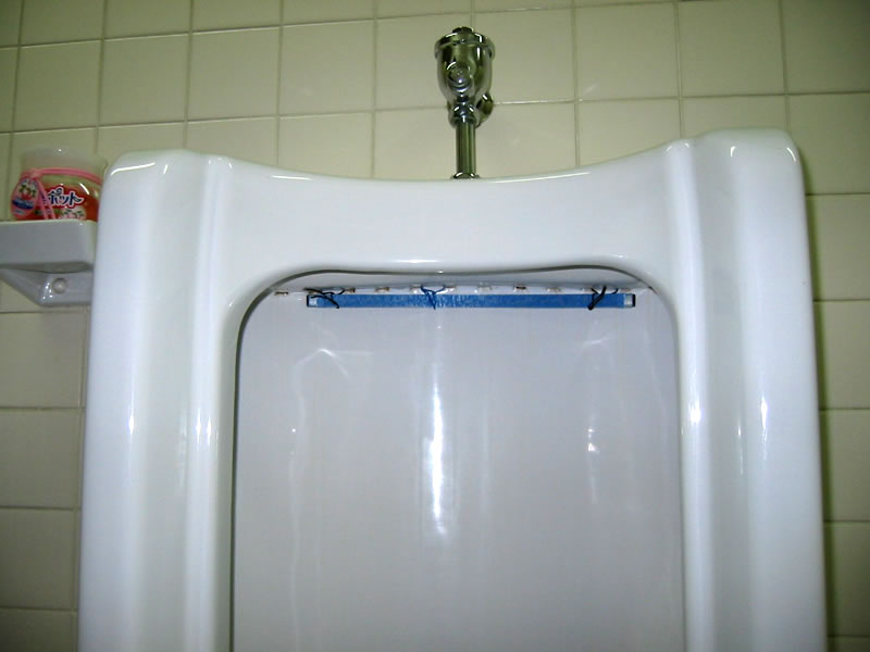 By installing a blue plate in front of the flushing outlet on the toilet bowl, every flush spreads biotic components (i.e., microbes) through the toilet bowl and into the drain with the flowing water.
